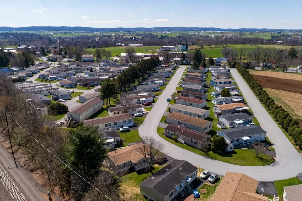 Aerial view of manufactured housing mobile home park in rural area.